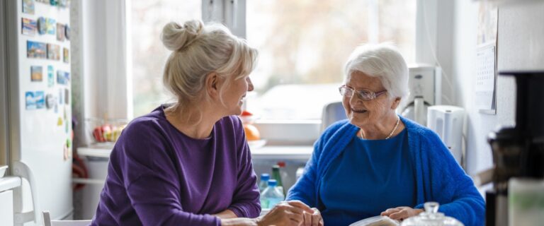 Woman spending time with her elderly mother at home